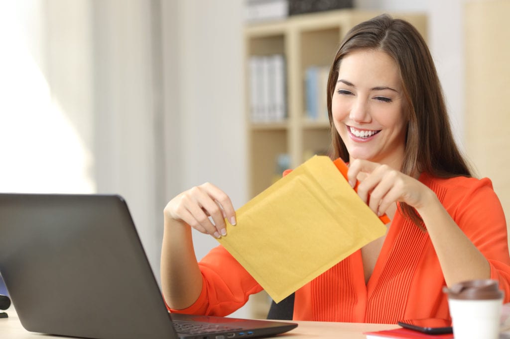 Woman sealing postage for meter